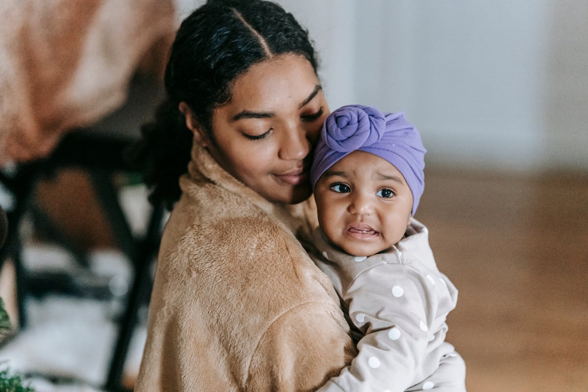 Happy ethnic mother with little black daughter